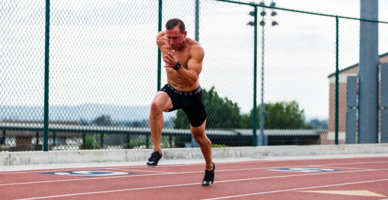Elite Steven Benedict running on an Olympic track.